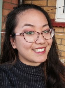 photograph of a young woman wearing glasses